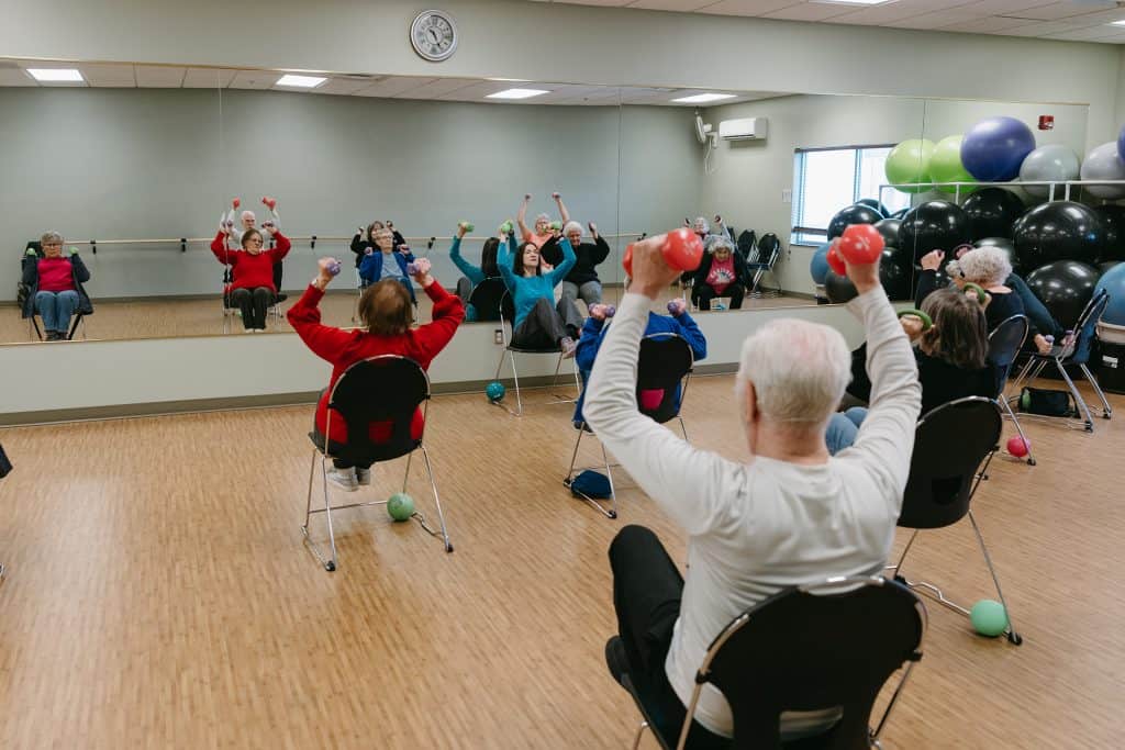 Older adults participating in seated exercise class at Four Pointes Center.
