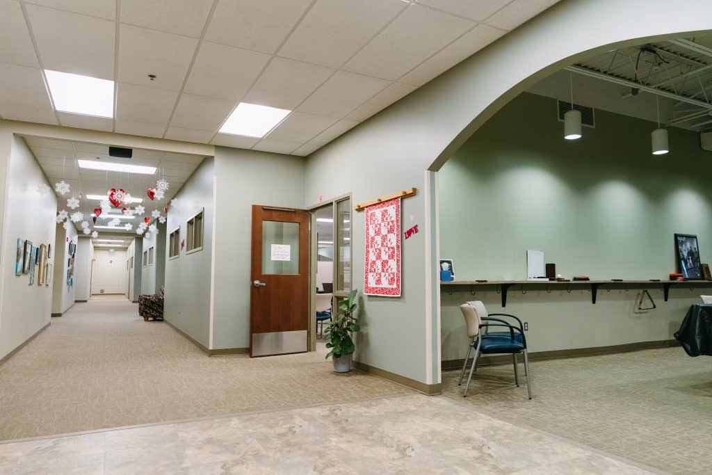 Modern office reception with holiday decorations and seating area.