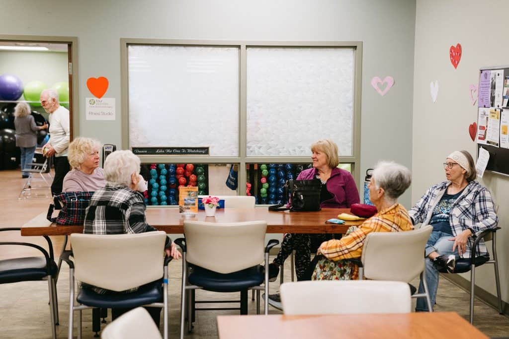 Elderly people participating in a fitness class at All Season Innovations facility.