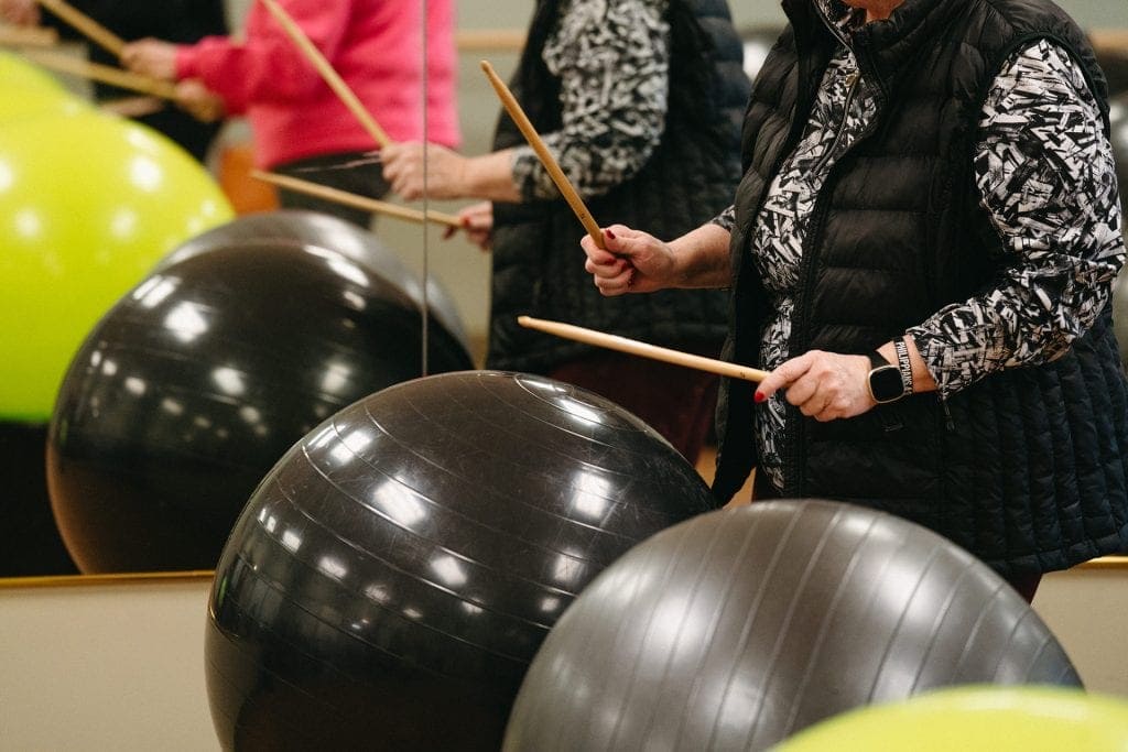 People exercising with stability balls in a fitness class.
