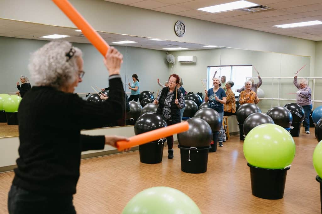 Senior women participating in a fitness class with exercise balls in a gym.
