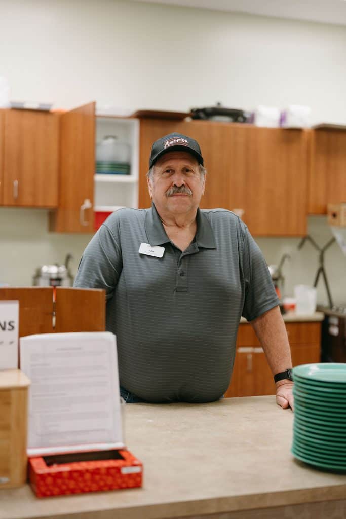 Staff member at Four Pointes Center for Successful Aging in kitchen area.