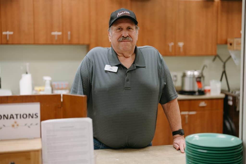 Friendly man in uniform at All Season Innovations customer service desk.