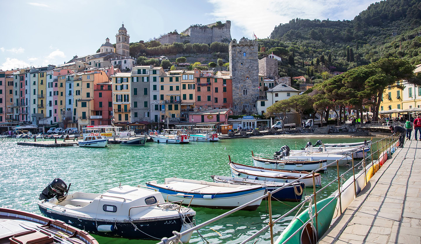 Immagine di Italgas: pittoresco porto italiano con barche e colorate case urbane sullo sfondo, simbolo di crescita comunitaria.