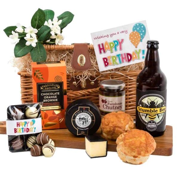 A birthday gift basket featuring beer, cheese, and nibbles.