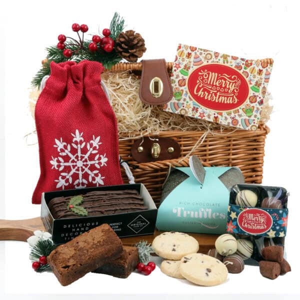 The Christmas Chocolate Lovers Gift Hamper is the ultimate festive treat, featuring an assortment of chocolates, cookies, and a yule log.