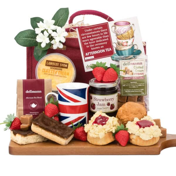A Gluten Free British Cream Tea including gluten free scones, clotted cream, jam, fudge, a mug with a Union Jack design, and millionaire shortbread.