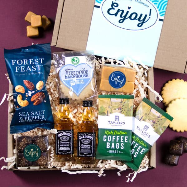 A gift box including 2 mini Jack Daniel's whisky bottles, Italian coffee, clotted cream fudge, chocolate truffles, shortbread and mixed nuts.