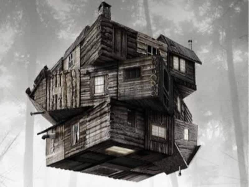A wooden cabin with multiple sections arranged in a complex, cube-like structure appears suspended in a foggy forest—perfect for fans of Horror Films.