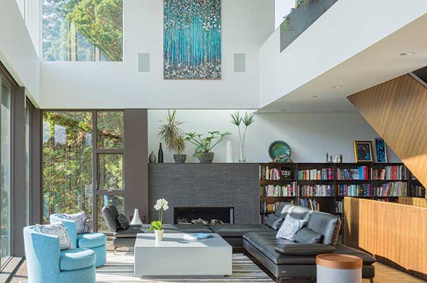 A modern living room with bookshelves and a fireplace.