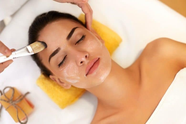 Face Treatment. Woman in Beauty Salon Gets Marine Mask