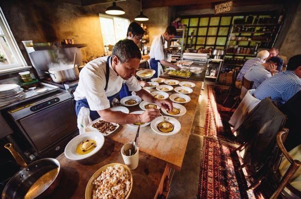 A group of people preparing food in a restaurant.