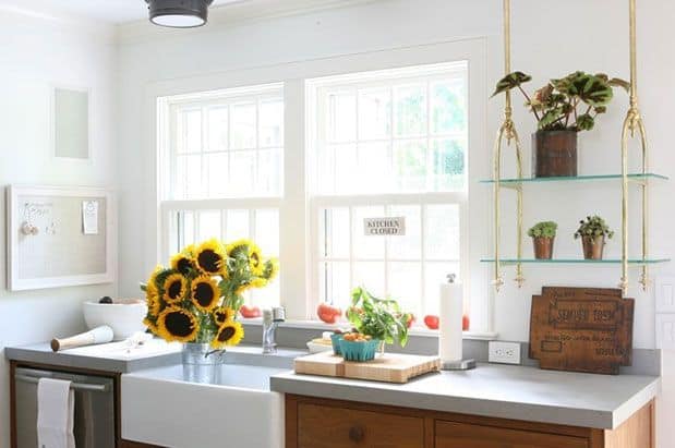 A kitchen with a wooden sink and sunflowers.