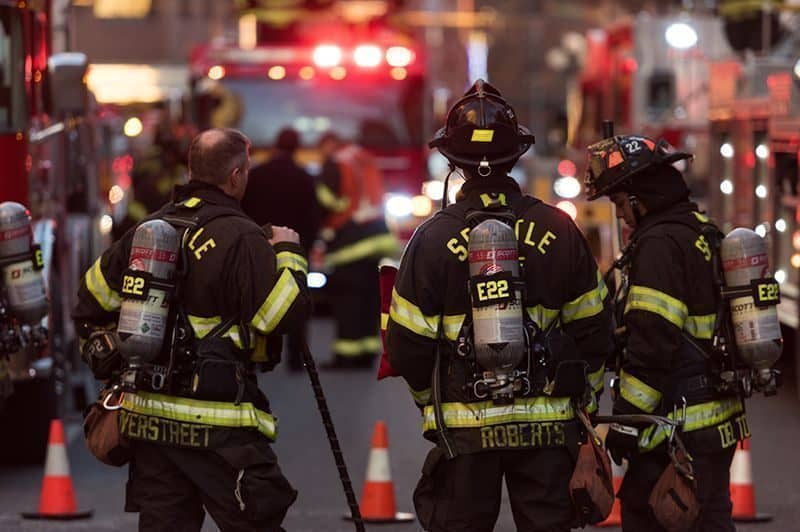 Seattle, USA - January 5, 2017: Firefighter at 1919 on 1st avenue late in the day by Pike Place Market after putting out a fire.