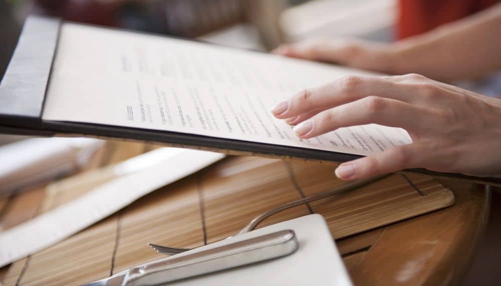 Close-up of woman's hands holding menu