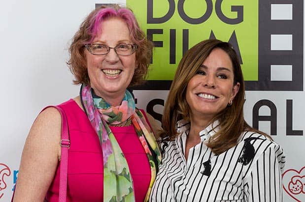 Two women posing for a photo at the dog film festival.