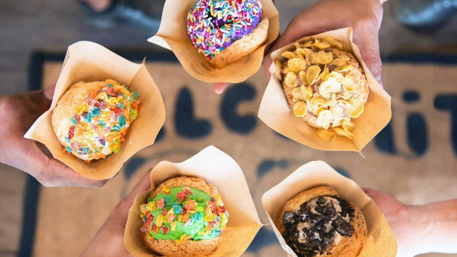 PuffyPandy_Pic02_16x9 Ice cream puffys topped with Fruity Pebbles, Oreos, Corn Flakes, and sprinkles.