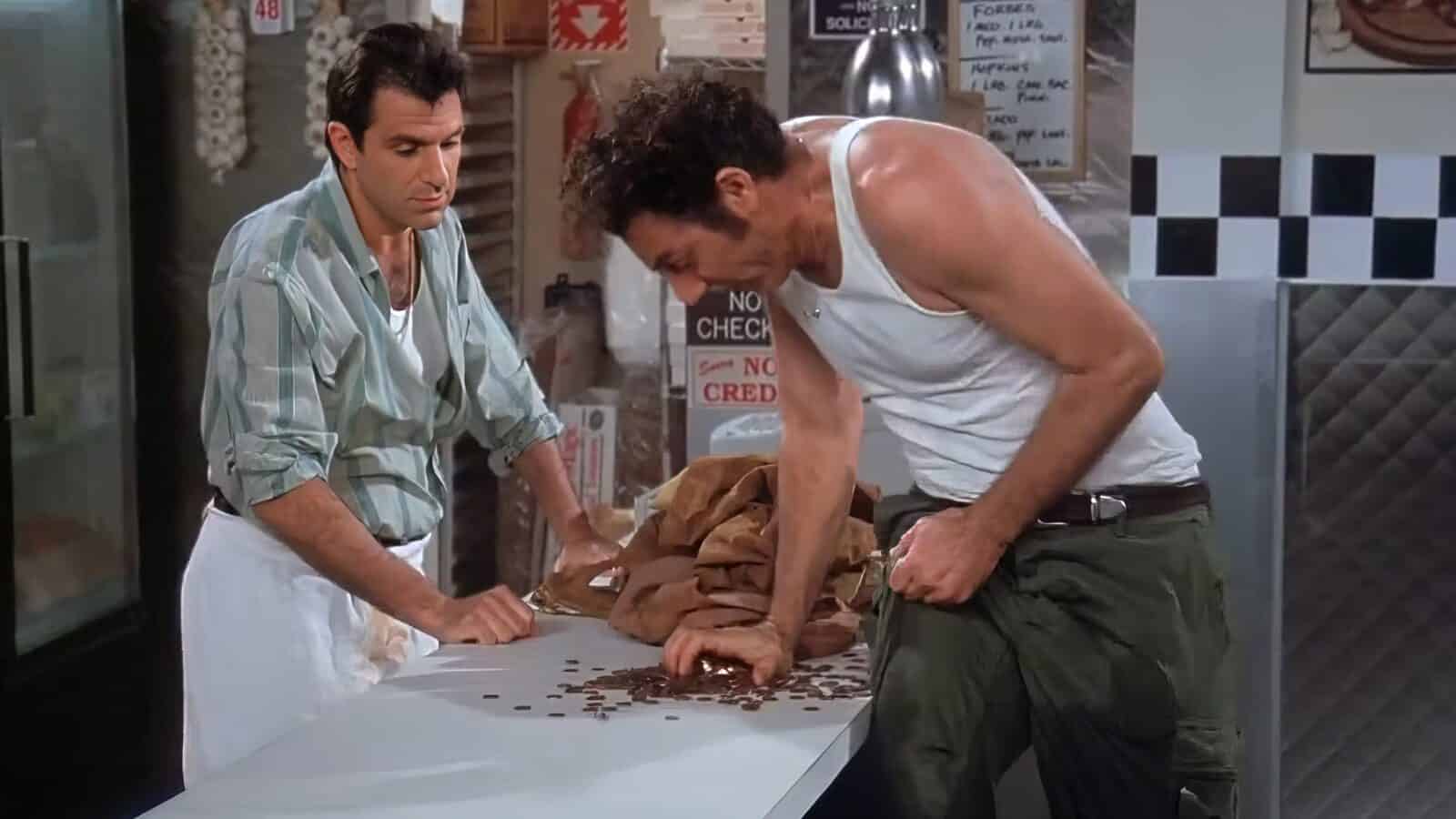 Kramer-And-Vittorio-In-Seinfeld_1600x900 Two men stand at a counter with spilled coffee beans. One man wears a striped shirt and apron, the other a tank top and pants. As they sort through the beans, it seems they're engaged in some impromptu "Making Cents," turning an everyday task into an exercise in budgeting.