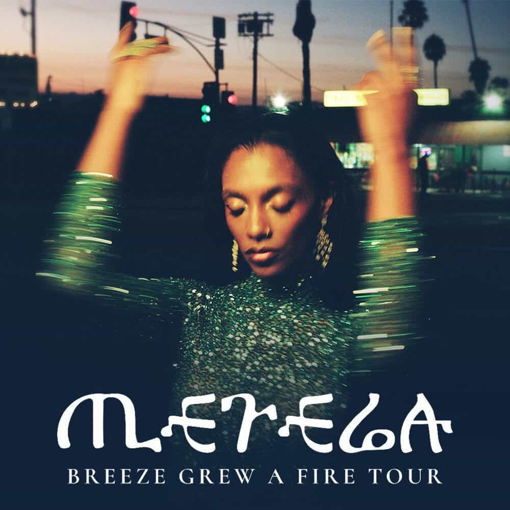 A person in a green sequin outfit raises their arms at dusk, with "Mereba Breeze Grew a Fire Tour – Must List 04-24-2025" overlaid at the bottom.