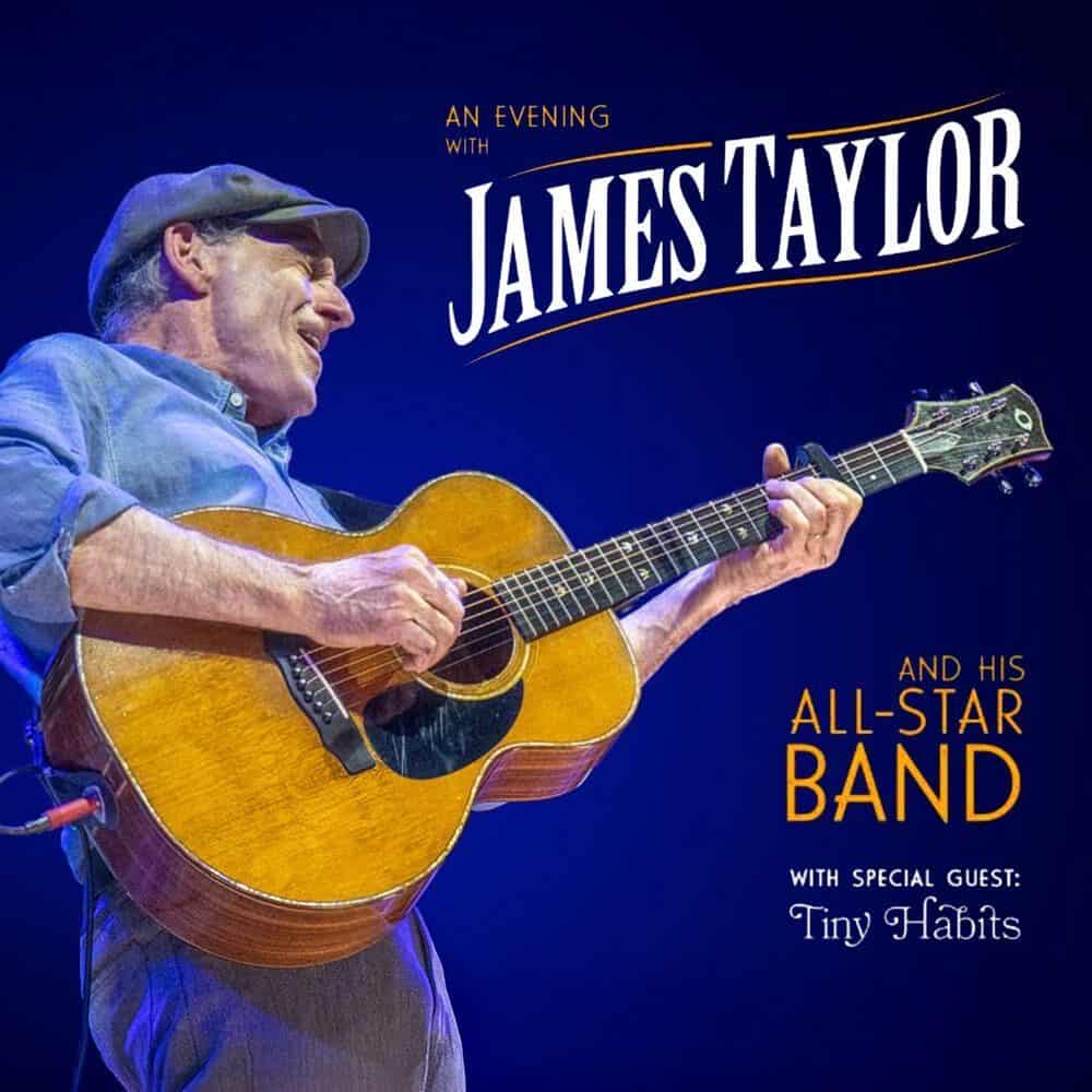 James Taylor plays acoustic guitar on stage. Don’t miss the Must List event—An Evening with James Taylor and His All-Star Band, with special guest Tiny Habits on 05-22-2025.