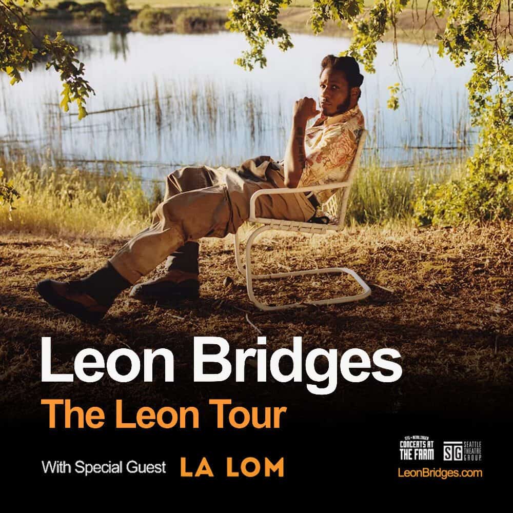 Musician Leon Bridges sits on a white chair by a lake, surrounded by grass and trees. Text reads: "Leon Bridges: The Leon Tour. With special guest La Lom. LeonBridges.com.