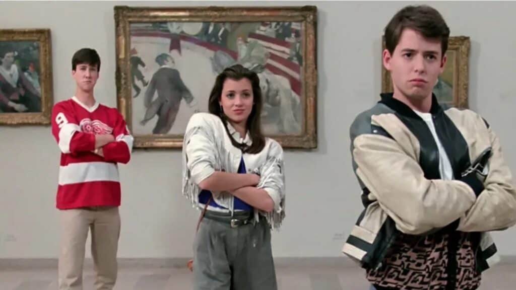 Three teenagers stand with arms crossed in front of impressionist paintings in an art gallery.
