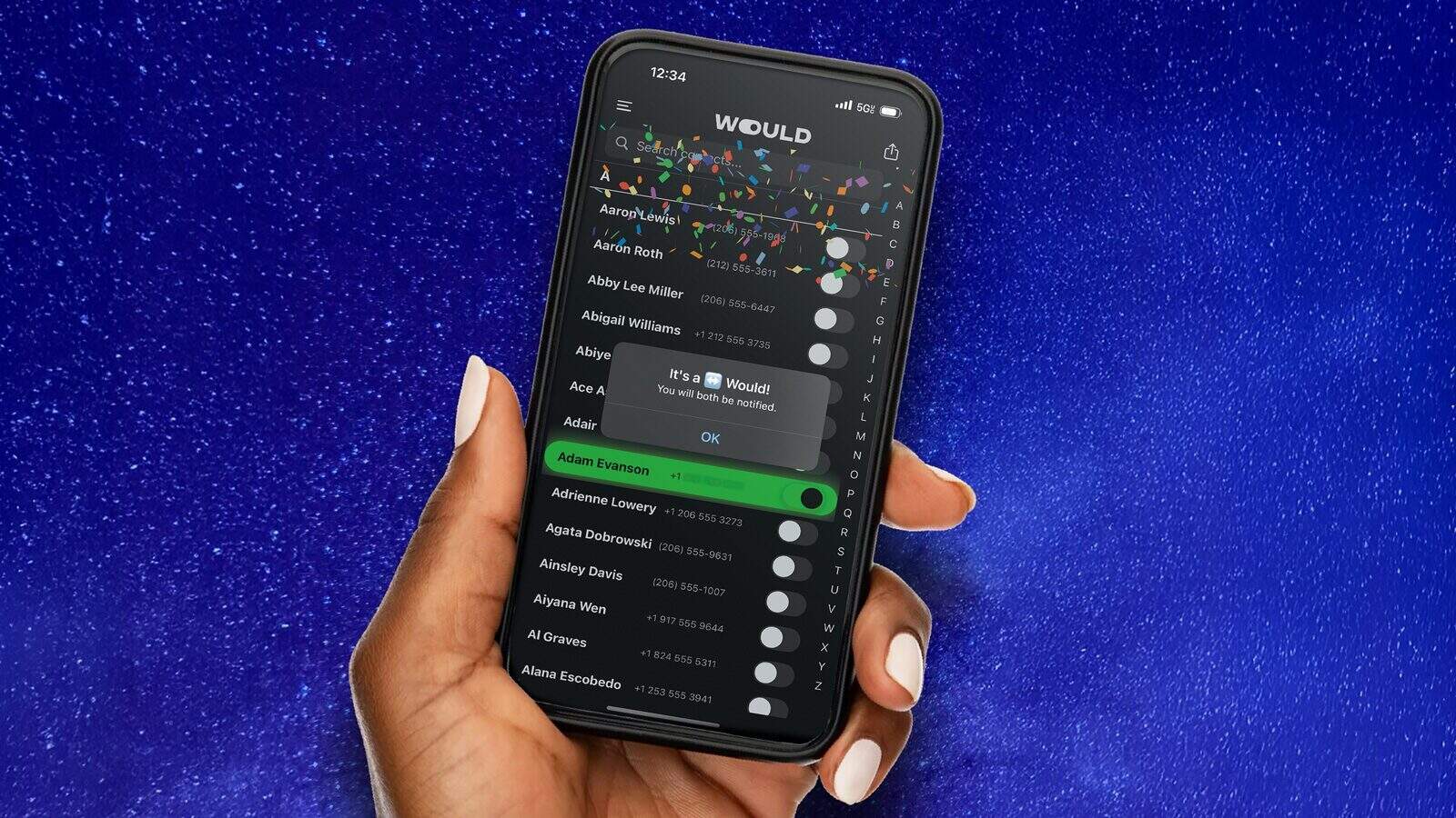 A hand holds a smartphone displaying the "WOULD" app with a notification congratulating the user on winning, set against a blue starry background—perfect for fans of online dating and exploring new dating apps.