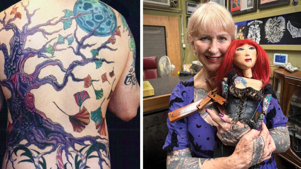 In this vibrant tattoo studio, the Ink Queen displays a stunning tree and blue moon tattoo on her back as she cradles a red-haired puppet—unique artifacts of her artistic journey.
