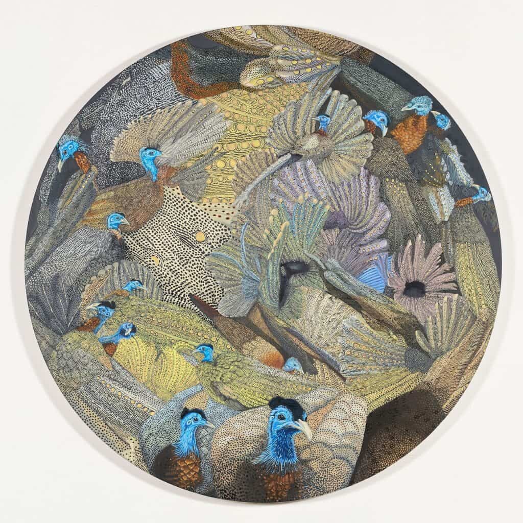 A circular artwork featuring multiple blue-headed birds with patterned wings, layered closely together in muted shades of yellow, brown, and gray.
