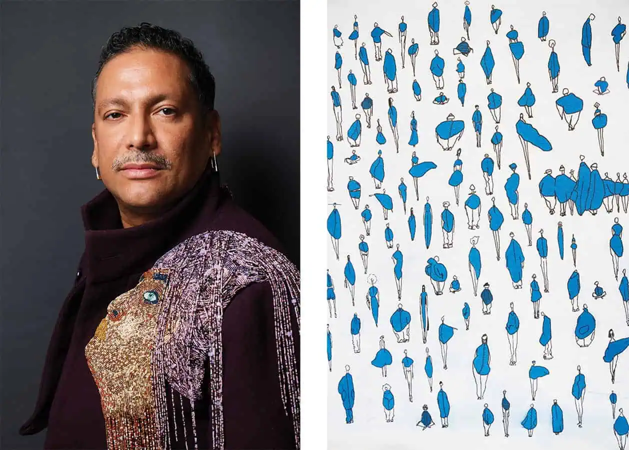 A person wearing a dark jacket with intricate beaded embroidery inspired by sustainable fashion stands beside an artwork featuring many small blue and black abstract human figures on a white background.