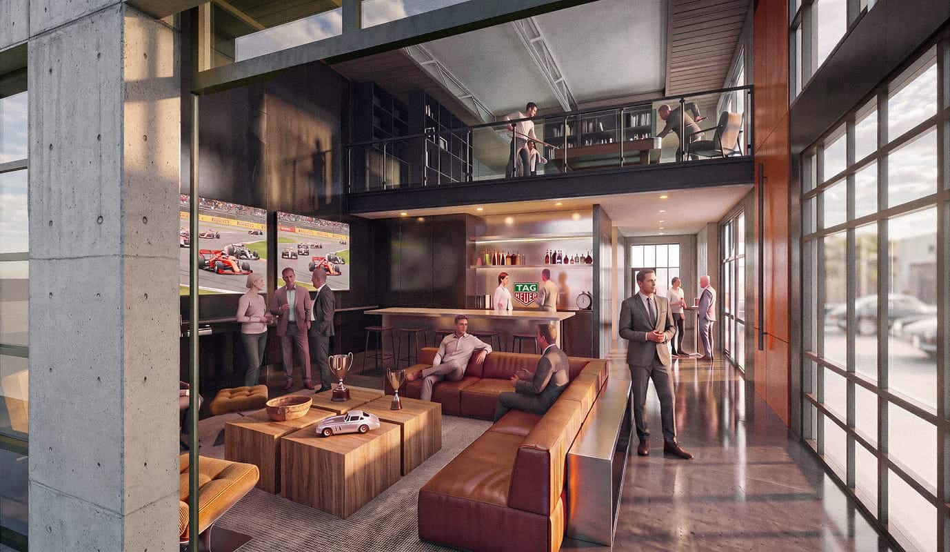 A modern lounge in Terminal One with people in business attire, leather sofas, racing decor featuring exotic automobiles, a bar area, and a mezzanine level overlooking thrilling Formula One scenes on wall screens.