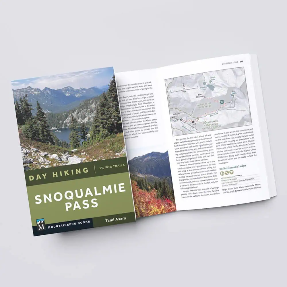 A perfect pick for any Seattle Father’s Day Gift Guide, "Day Hiking Snoqualmie Pass" by Tami Asars is shown closed and open to a map and trail info page on a white surface.
