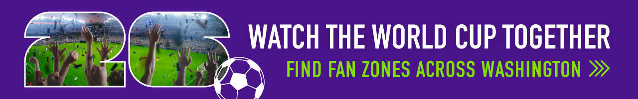 Banner with text "Watch the World Cup Together. Find fan zones across Washington," featuring images of a crowded soccer stadium spelling out 2026—perfect for readers of Seattle magazine eager to join in the excitement.