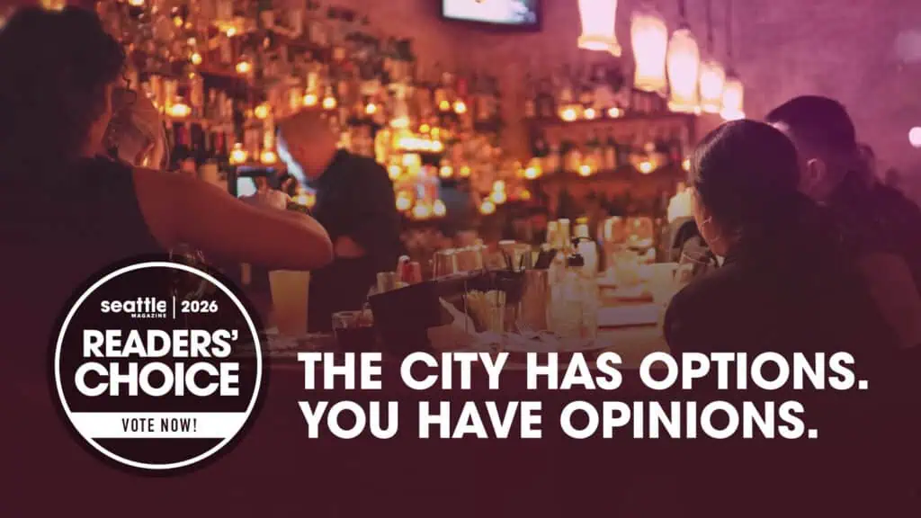 A busy bar with people sitting at the counter, featuring a “Seattle Readers’ Choice 2026” badge and the text, “The city has options. You have opinions. Vote now for Seattle Mag’s Reader’s Choice Awards!”.