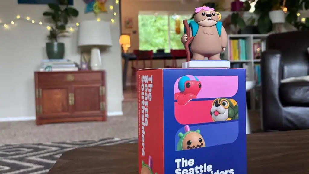 A Seattle Southsiders mystery box featuring a cartoon otter figure on top and illustrations of other characters on the side.
