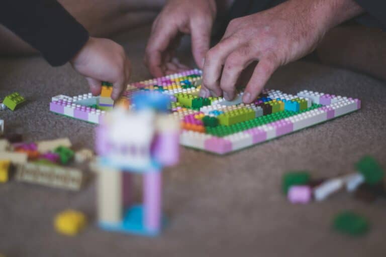 Grandfather and grandchild playing with Legos