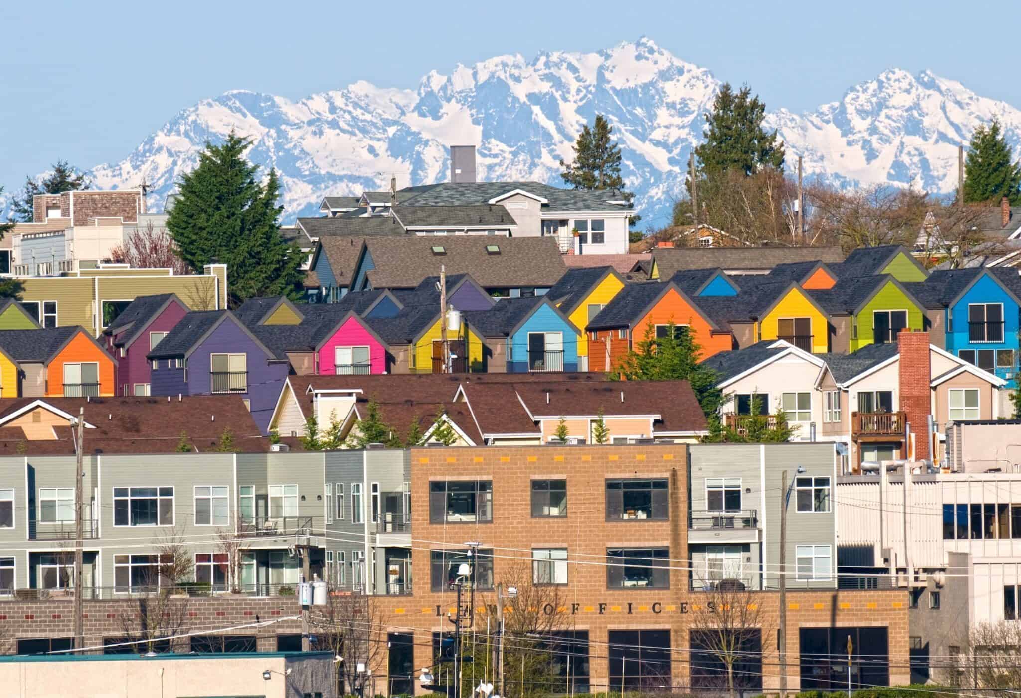Row of colorful townhouses and Olympic Mountain range from Seattle WA