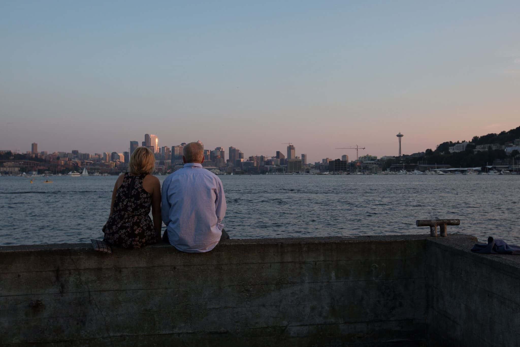 Seattle, Washington USA - August 24, 2014: On a beautiful summer evening, couple enjoy sunset on Gasworks Park in Seattle.