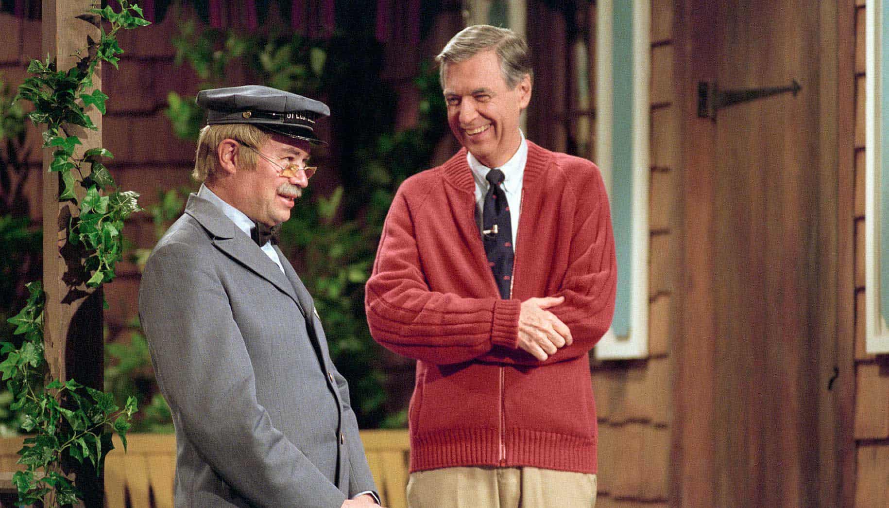 Fred Rogers and David Newell in costume on porch set of Mister R