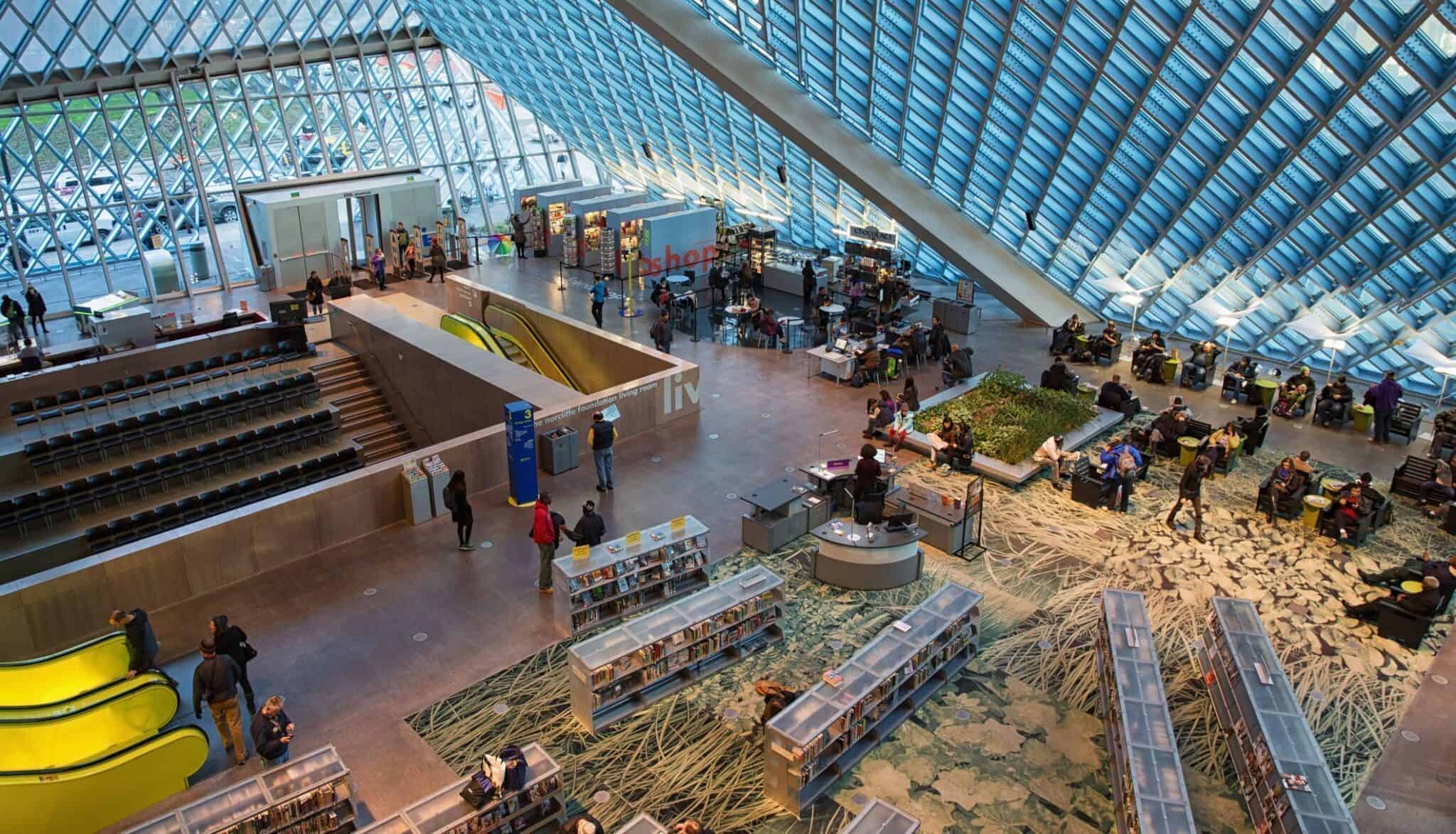 Seattle, USA - December 29, 2014: View of the main hall at the Seattle central library designed by the Dutch Architect Rem Koolhaas, peoples relaxing and enjoying modern US architecture as well as looking for books. The library opened to public in 2004.