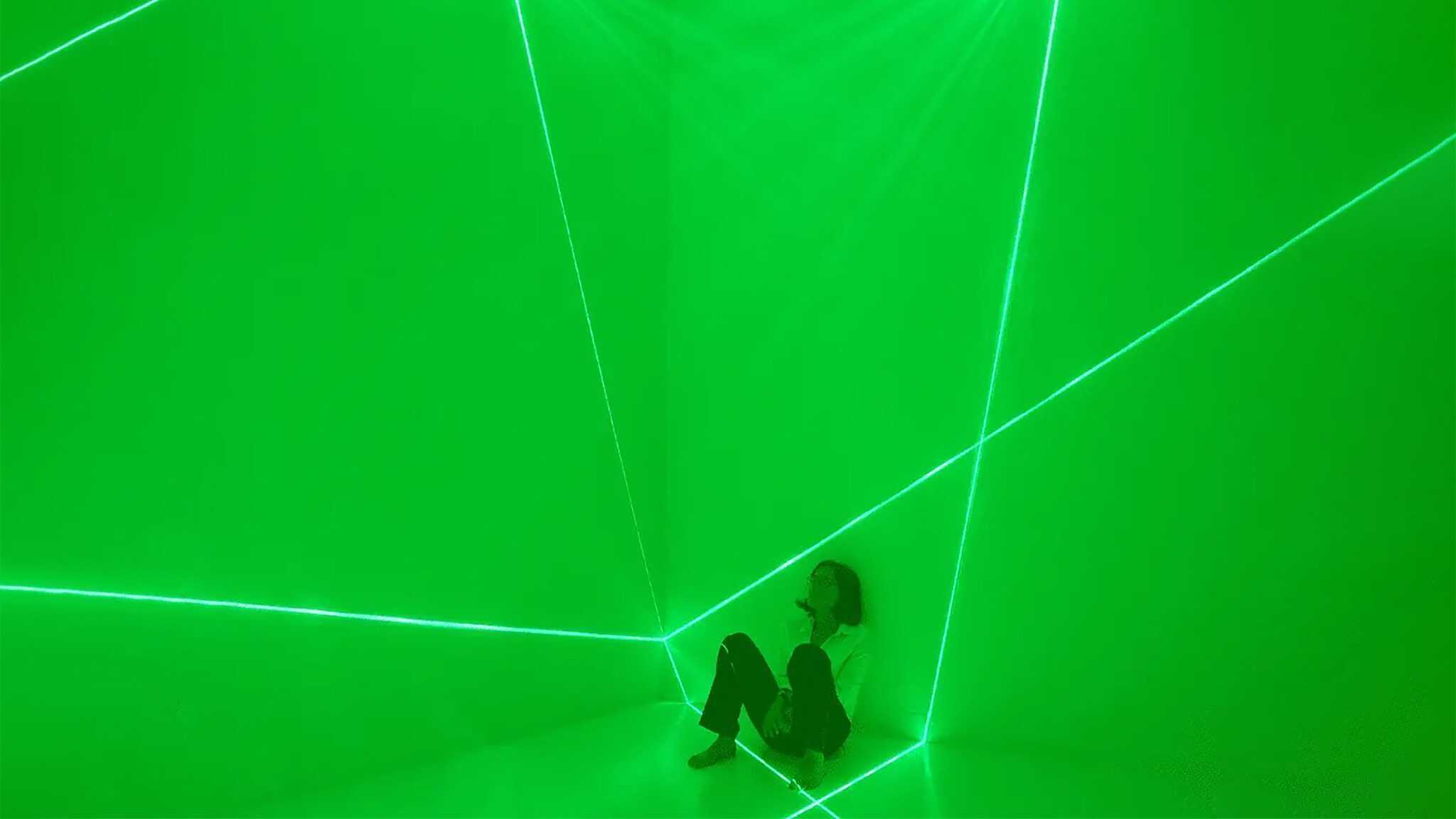 A photo of the artist is framed within the luminous planes projected against the walls at Jack Straw Gallery in Seattle