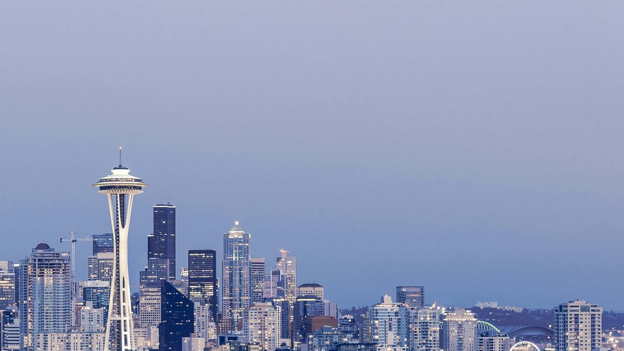 Seattle skyline at dusk with the Space Needle prominently featured, surrounded by modern skyscrapers and buildings, capturing the city’s rhythm like The Pulse of urban life.