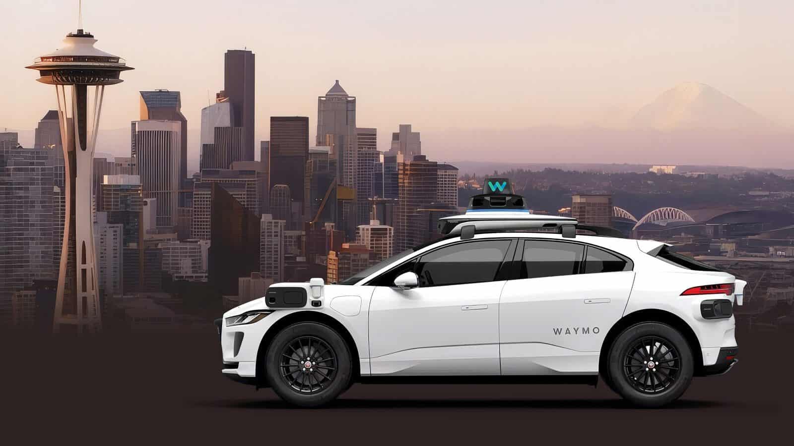 A white Waymo self-driving car is parked in front of the Seattle skyline, with the Space Needle and Mount Rainier visible in the background.