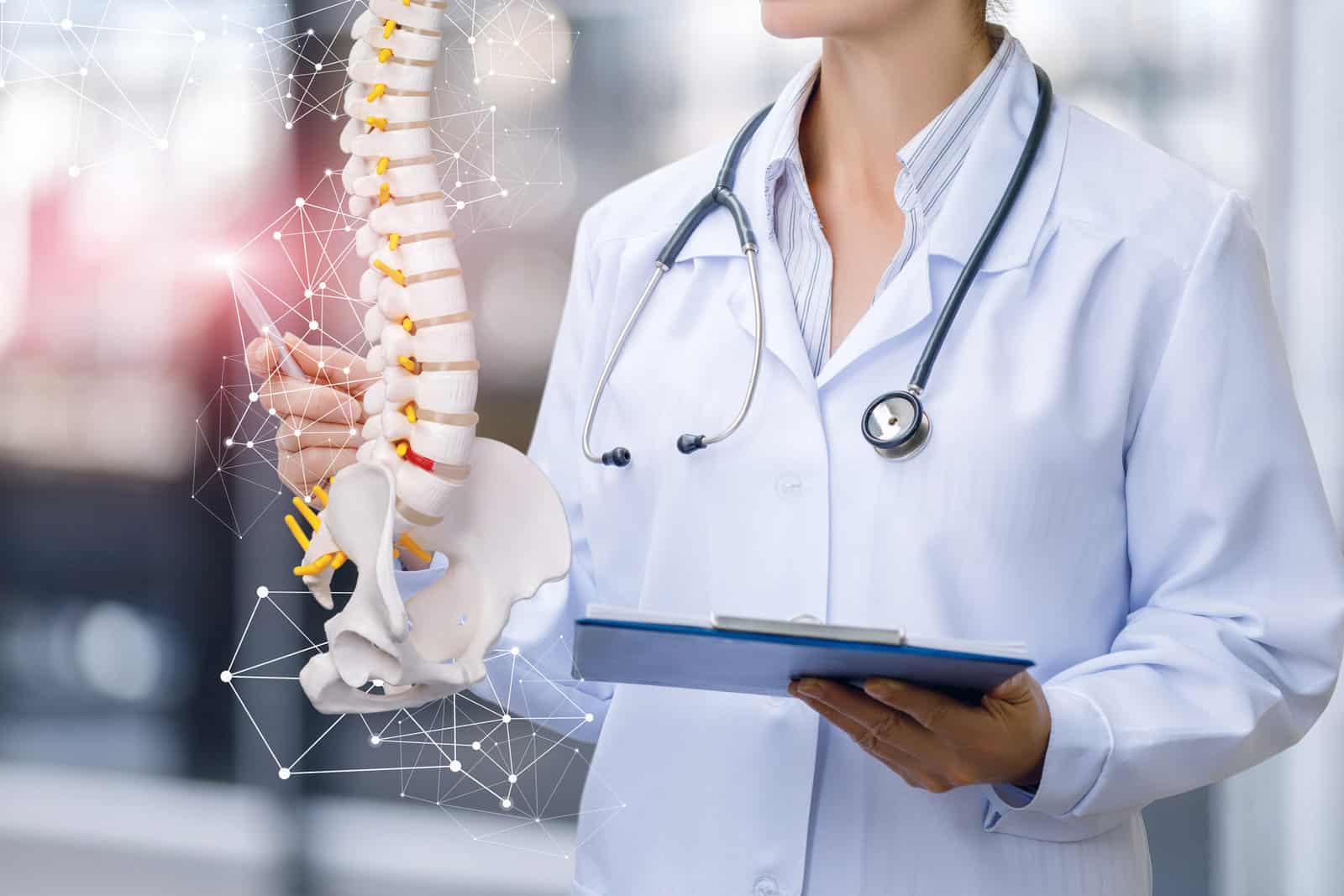 a-medical-worker-shows-the-spine-on-blurred-background