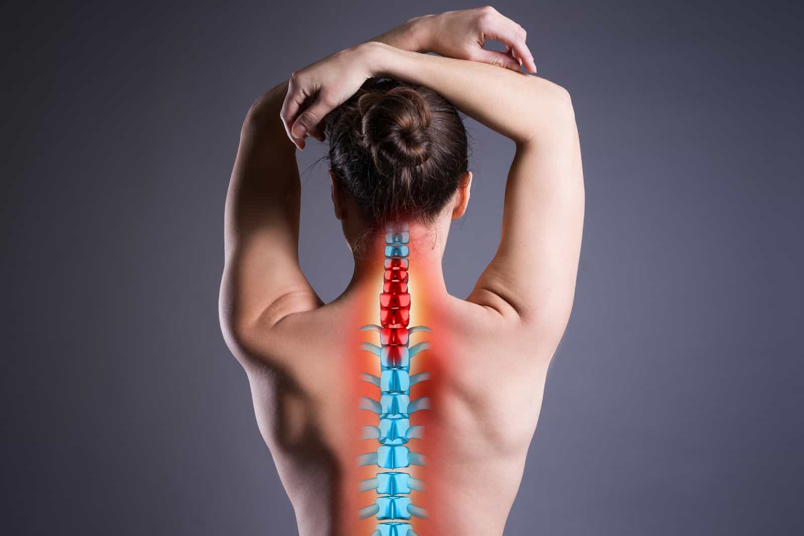 pain-in-the-spine-woman-with-backache-on-gray-background-back-injury