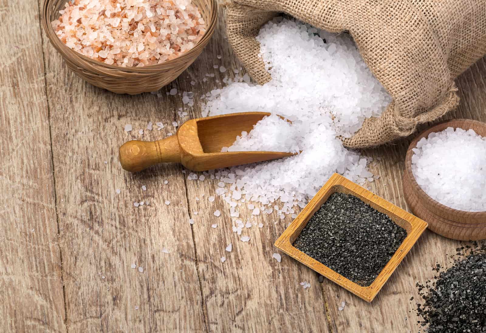 mix-of-different-salt-types-on-wooden-background-sea-salts-black-and-pink-himalayan-salt-crystals-collection-of-different-types-of-salt-in-the-bag-and-with-wooden-spoon