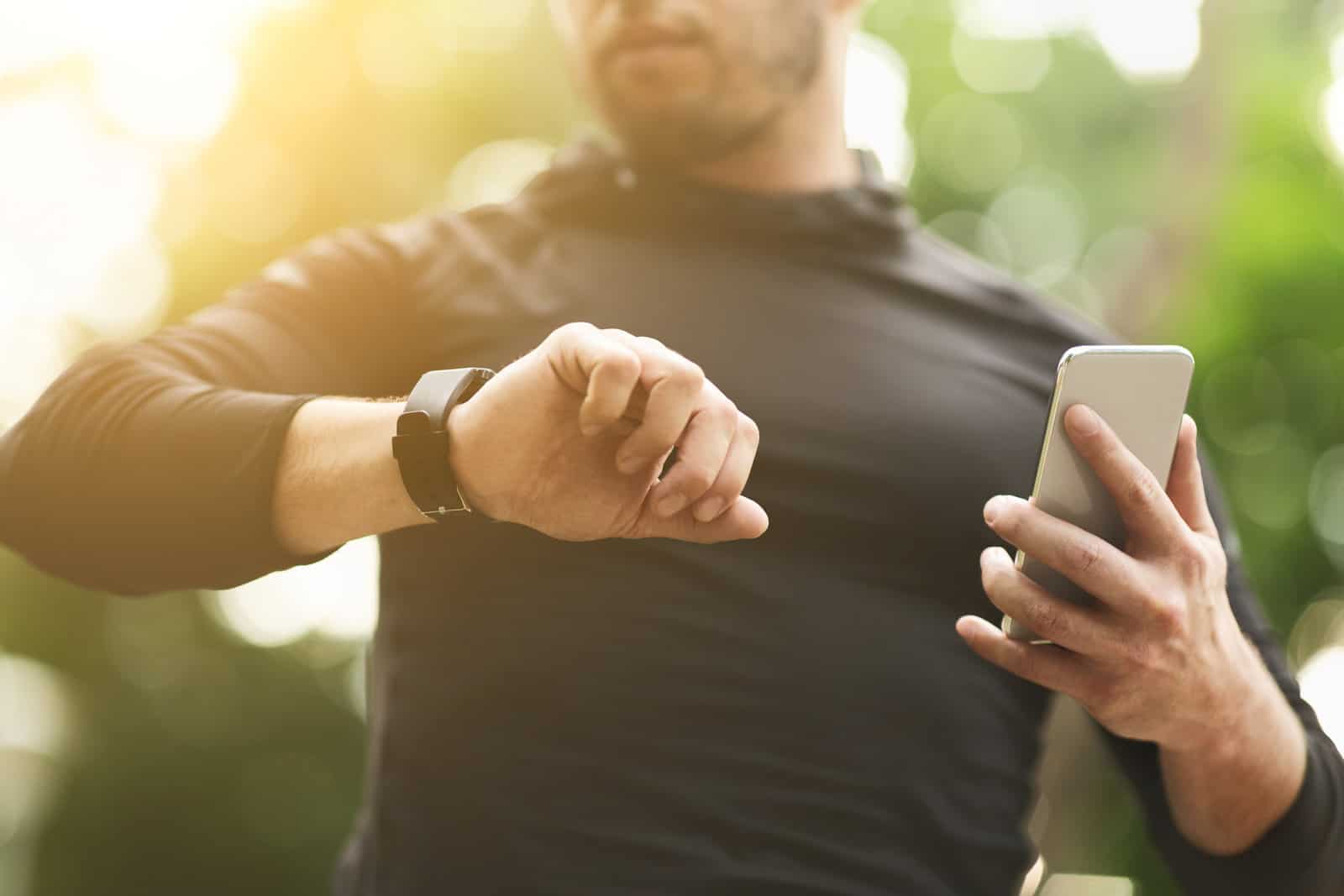 closeup-of-unrecognizable-man-checking-workout-data-on-fitness-tracker-after-intensive-training-outdoors-free-space