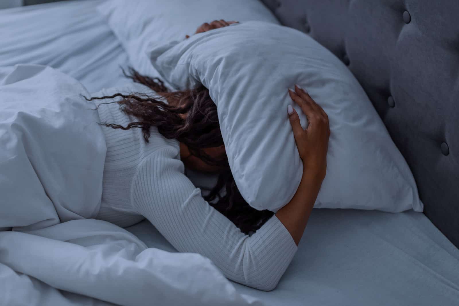 sleeping-problem-stressed-african-american-lady-lying-alone-in-bed-covering-head-under-pillow-feeling-afraid-or-depressed-suffering-from-insomnia-or-mental-problems-after-breakup