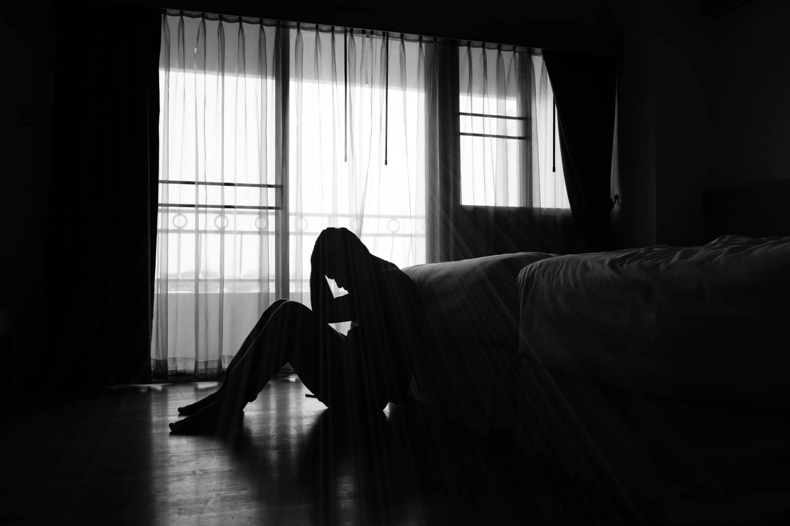 silhouette-of-depressed-man-sitting-in-the-private-room