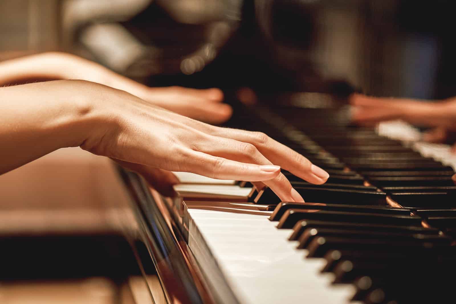 favorite-classical-music-close-up-view-of-gentle-female-hands-playing-a-melody-on-piano-while-taking-piano-lessons-musical-instrument-music-education-piano-keyboard